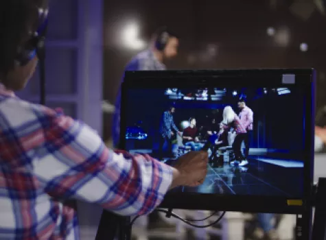 Producer Examining Monitor During Stage Performance Filming