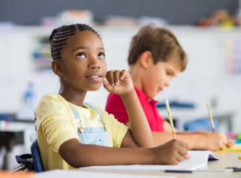 Young Black Female Child Sitting at Classroom Desk