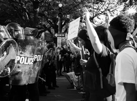 Police in riot gear facing protestors