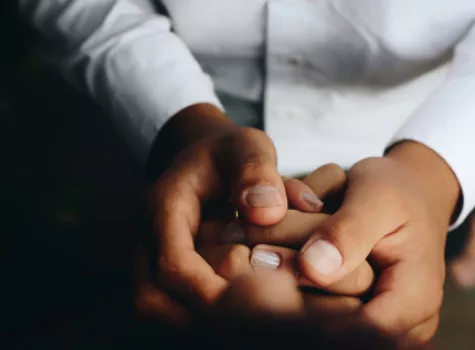 Close-up - Adult hands holding child hands