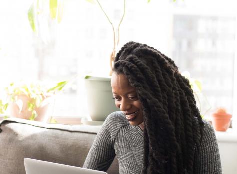 Young Black Female - Solo - on laptop - smiling