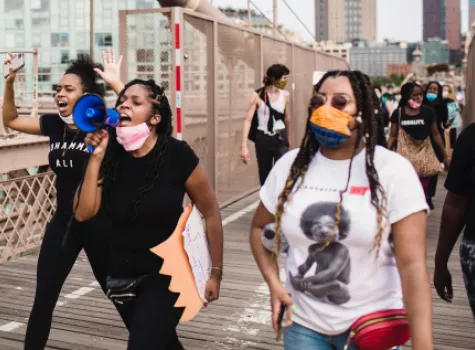 Group at rally or protest - females in forefront - with bullhorn