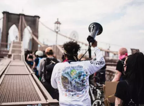 Group marching over Brooklyn Bridge