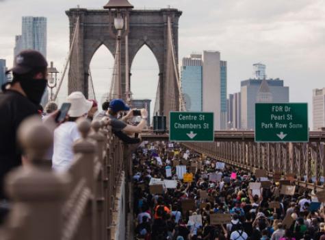 Group marching over Brooklyn Bridge
