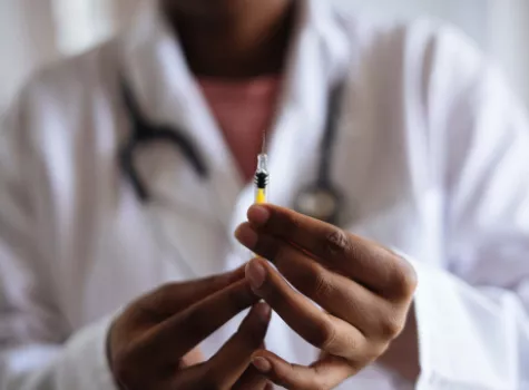 Close-up Doctor Hands holding Syringe