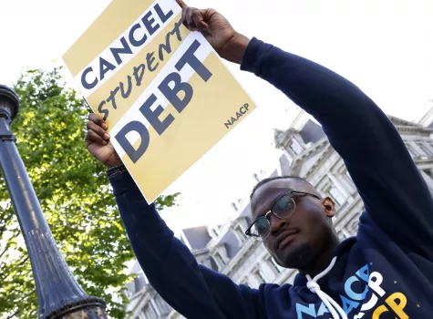 Wisdom Cole - Holding Cancel Student Debt Sign