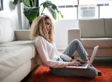 Young Black Female in Living Room with Laptop - Solo
