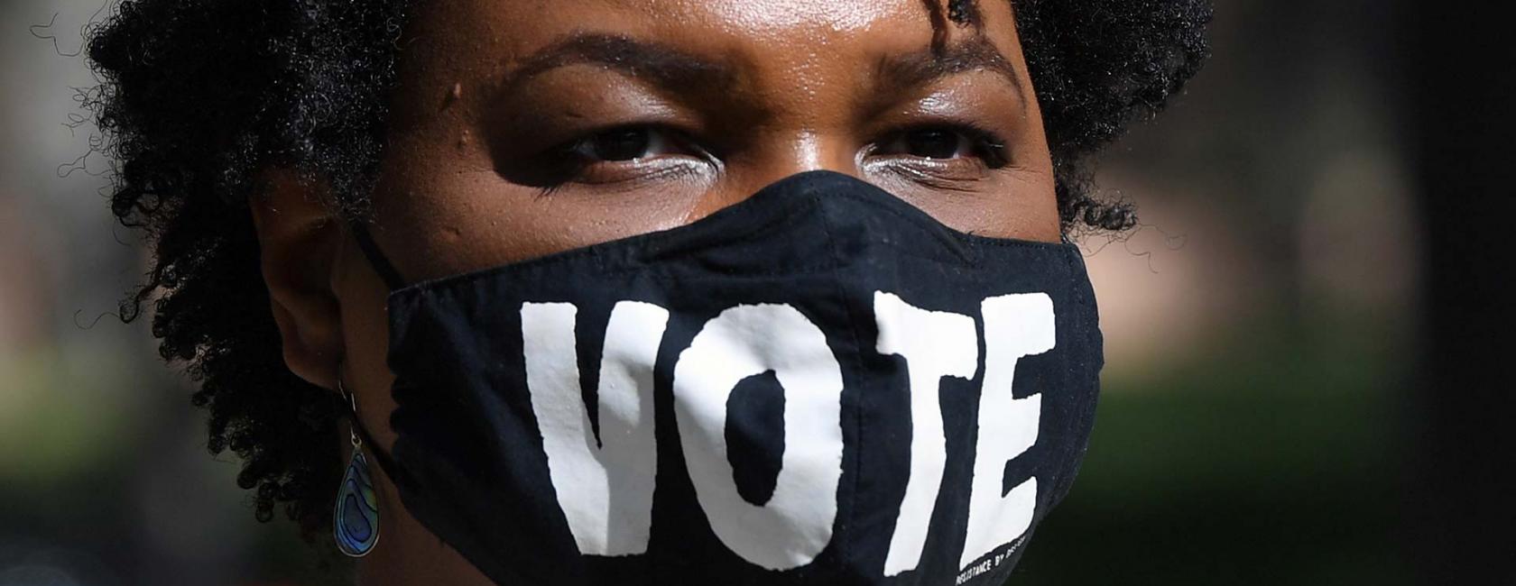 Close-up - Stacey Abrams wearing vote face mask