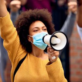 Black Female in Protest - Solo - Raised Fist - Wearing Mask