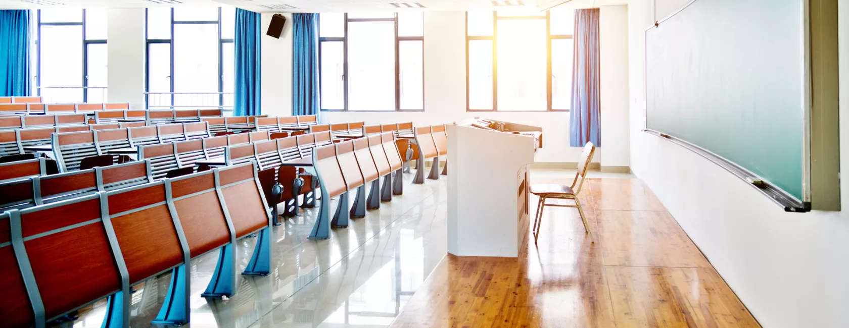 Unoccupied Classroom with Desks and Chairs in the Daytime